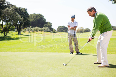 Golfing friends teeing off