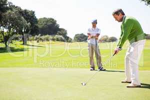 Golfing friends teeing off