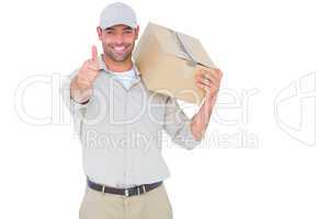 Delivery man with cardboard box gesturing thumbs up