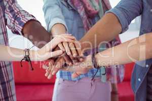 Fashion students putting hands together