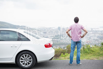 Man looking at the view near his car