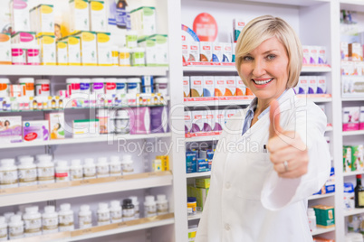 Positive blonde pharmacist with thumb up