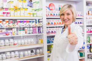 Positive blonde pharmacist with thumb up