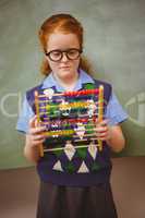 Portrait of cute little girl holding abacus
