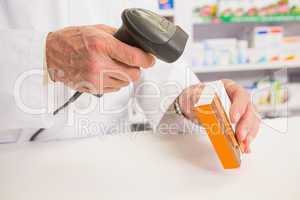 Pharmacist scanning medication with a scanner