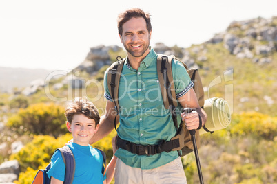 Father and son hiking through mountains