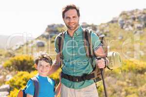 Father and son hiking through mountains