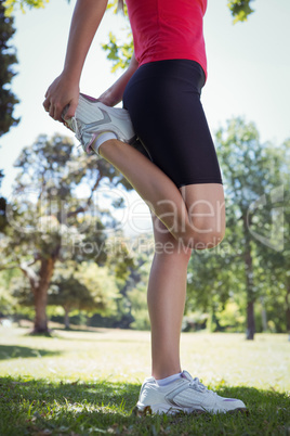 Fit woman stretching her leg