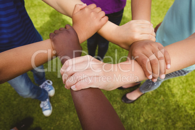 Children holding hands together at park
