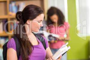 College students reading books in library