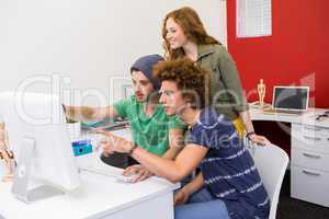 Team looking at computer screen in office