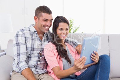 Couple using digital tablet together