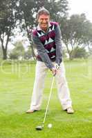 Golfer swinging his club on the course