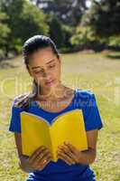 Woman reading book in park