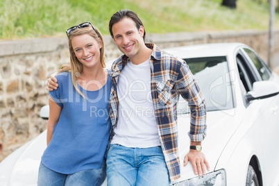 Couple leaning on the bonnet