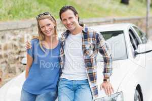 Couple leaning on the bonnet