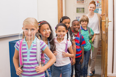 Cute pupils smiling at camera in classroom Cute pupils smiling at camera in classroom