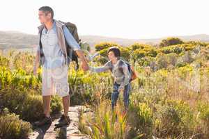 Father and son hiking through mountains