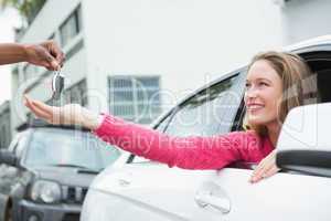 Young woman getting her new car key