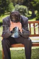 Businessman thinking in the park