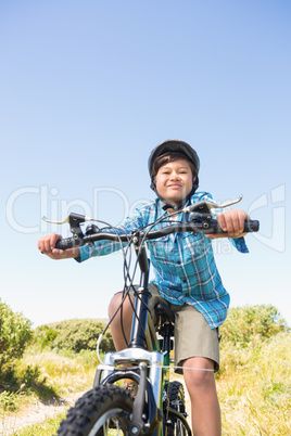 Little boy biking through mountains
