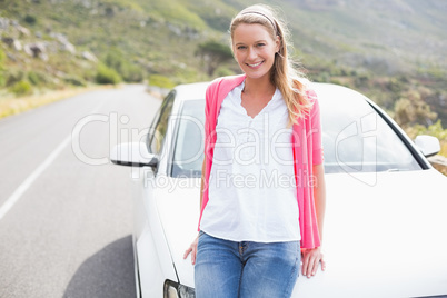 Pretty blonde leaning on the bonnet