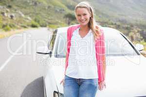 Pretty blonde leaning on the bonnet