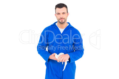 Mechanic wiping hands with cloth