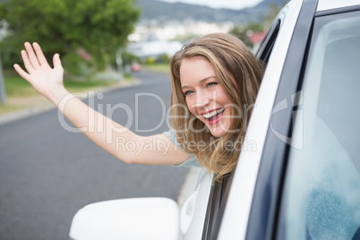 Young woman smiling and waving