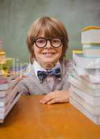 Boy with stack of books in classroom