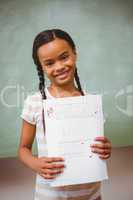 Portrait of cute little girl holding paper