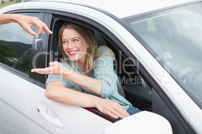 Young woman getting her new car key