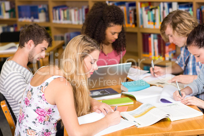 College students doing homework in library