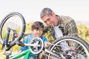 Father and son repairing bike
