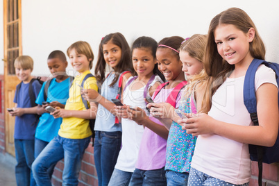 Cute pupils using mobile phone