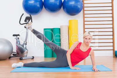 Blonde woman working on exercise mat