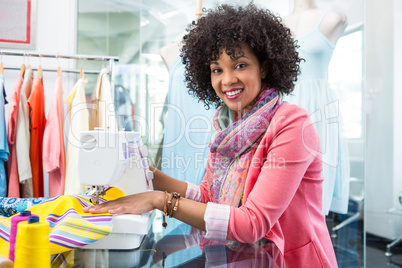 Female fashion designer using sewing machine