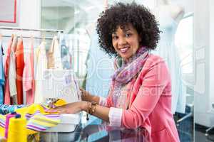 Female fashion designer using sewing machine