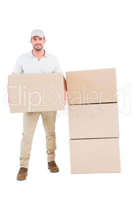 Confident delivery man holding cardboard box