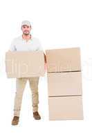 Confident delivery man holding cardboard box