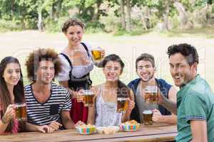 Pretty oktoberfest girl serving friends