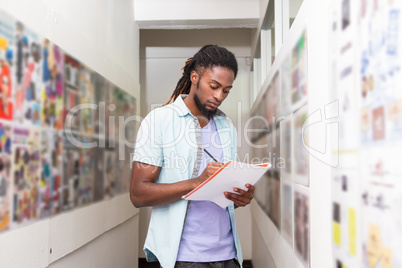 Handsome casual businessman writing notes