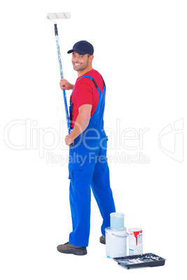 Handyman painting with roller on white background