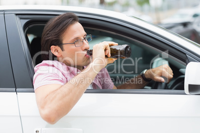 Man drinking beer while driving