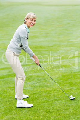 Lady golfer on the putting green