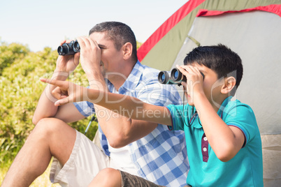 Father and son beside their tent in the countryside