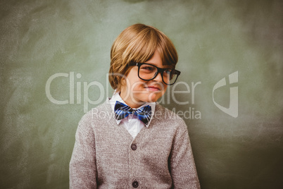 Boy smiling in front of blackboard