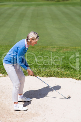 Female golfer taking a shot