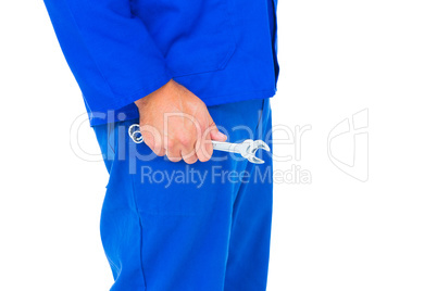 Mechanic holding spanners on white background