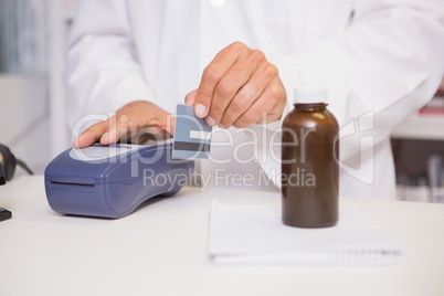 Pharmacist using keypad with credit card